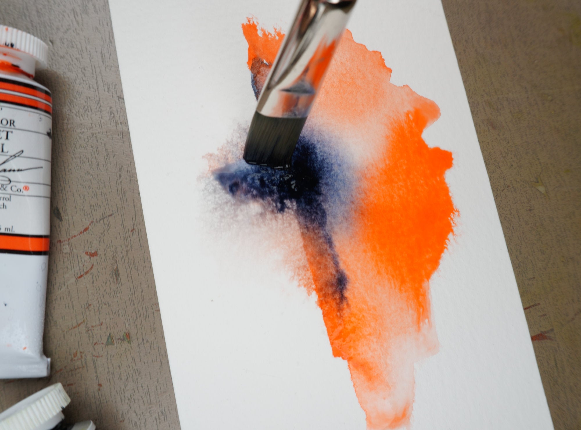 Flat brush applying M. Graham watercolour pigments on cotton watercolour paper. An image from Haidi Hildemore's studio.